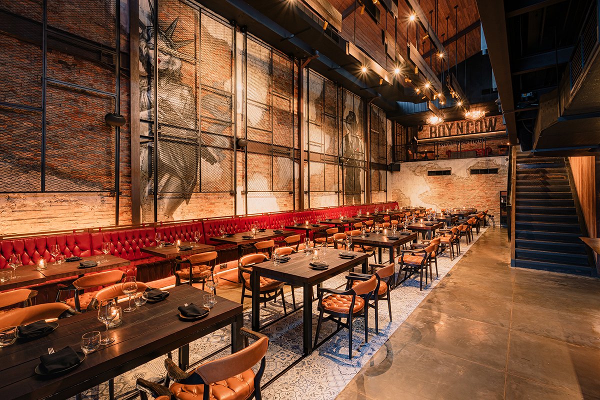 Interior of Boy 'N' Cow Restaurant at night with lamps