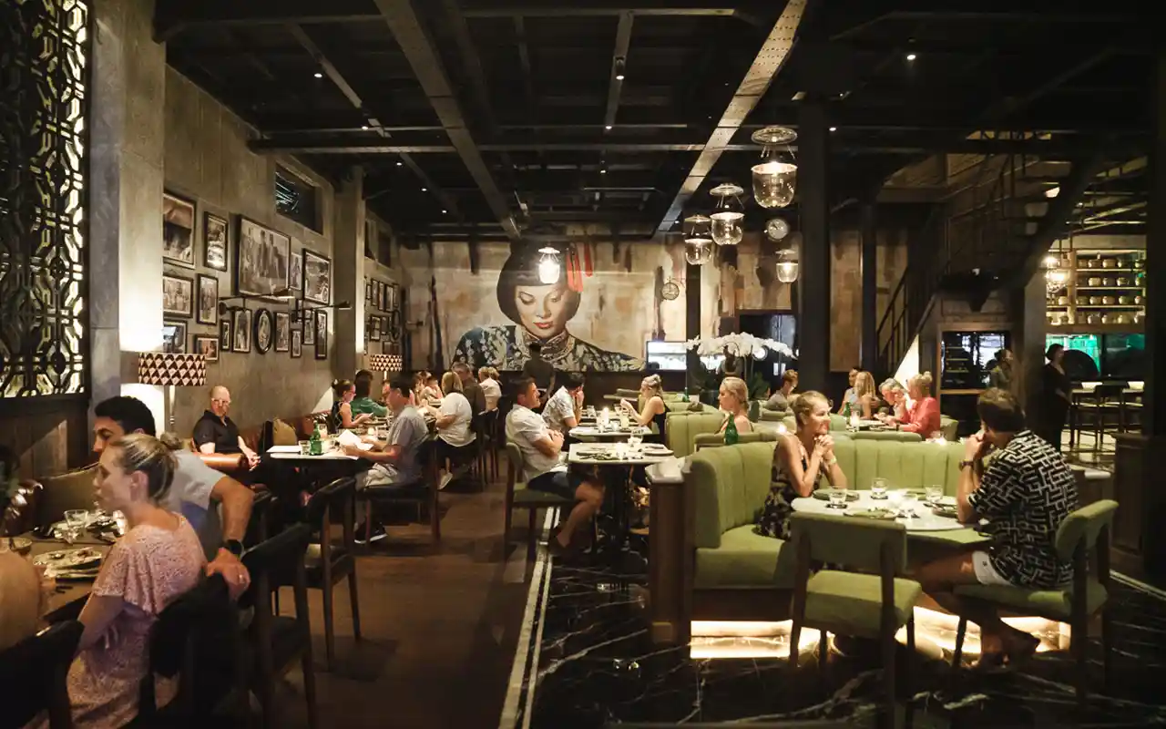 People eating at Mamasan with mural painting